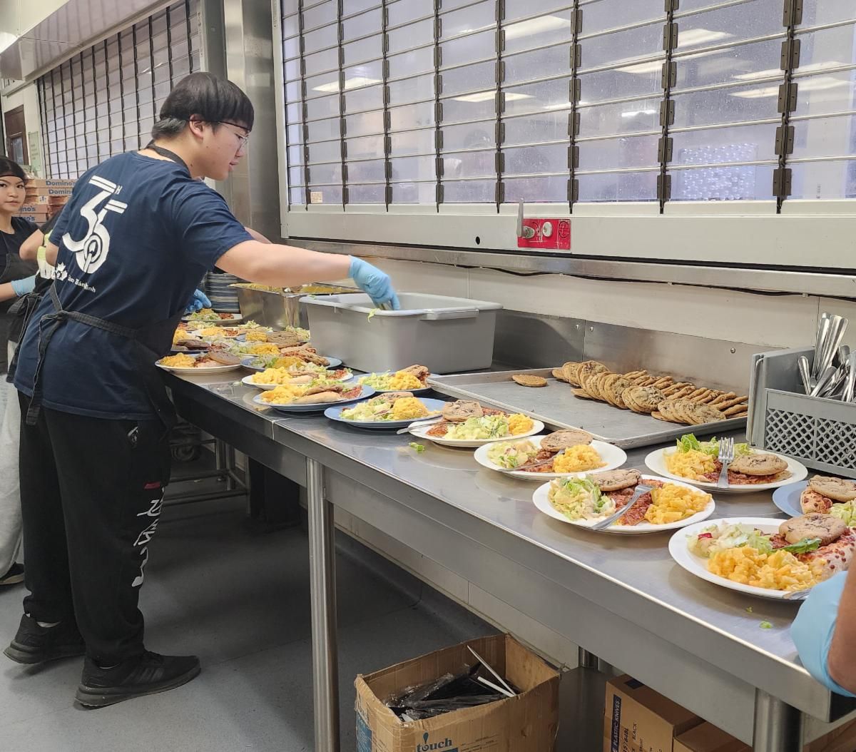 a person prepares meals in siloam's kitchen